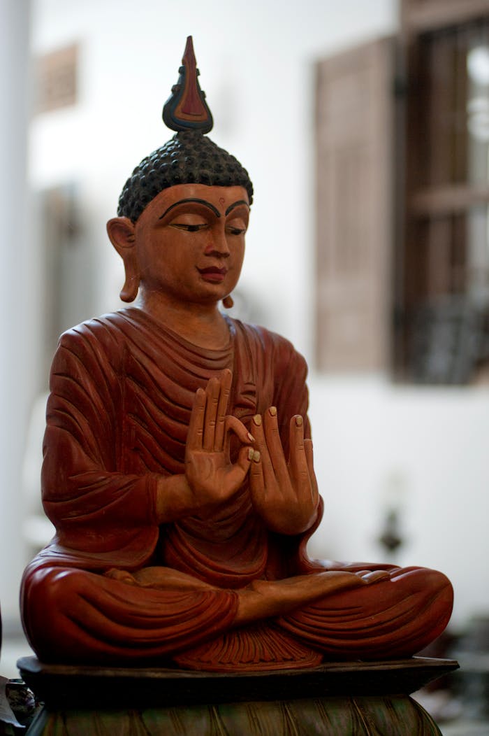 Home A peaceful wooden Buddha statue symbolizing tranquility and spirituality indoors.